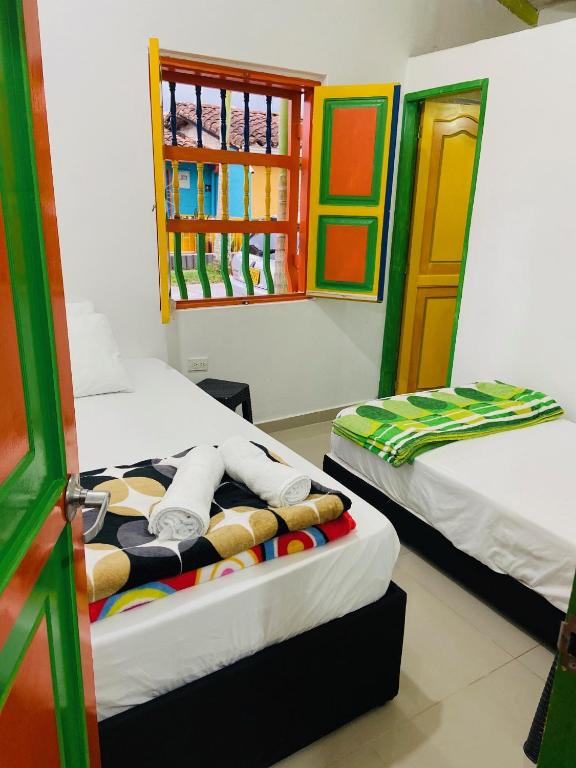 Postel nebo postele na pokoji v ubytování casa hostal las palmeras