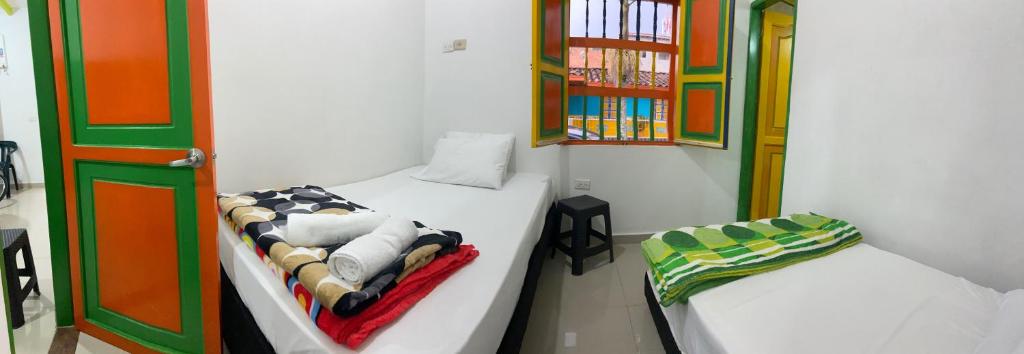 Postel nebo postele na pokoji v ubytování casa hostal las palmeras