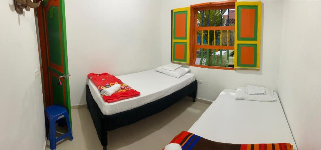 Postel nebo postele na pokoji v ubytování casa hostal las palmeras