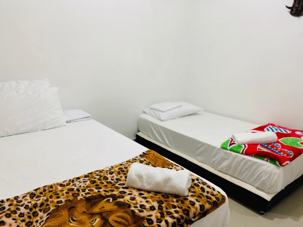 Postel nebo postele na pokoji v ubytování casa hostal las palmeras
