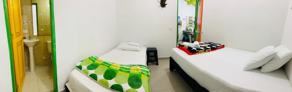 Postel nebo postele na pokoji v ubytování casa hostal las palmeras