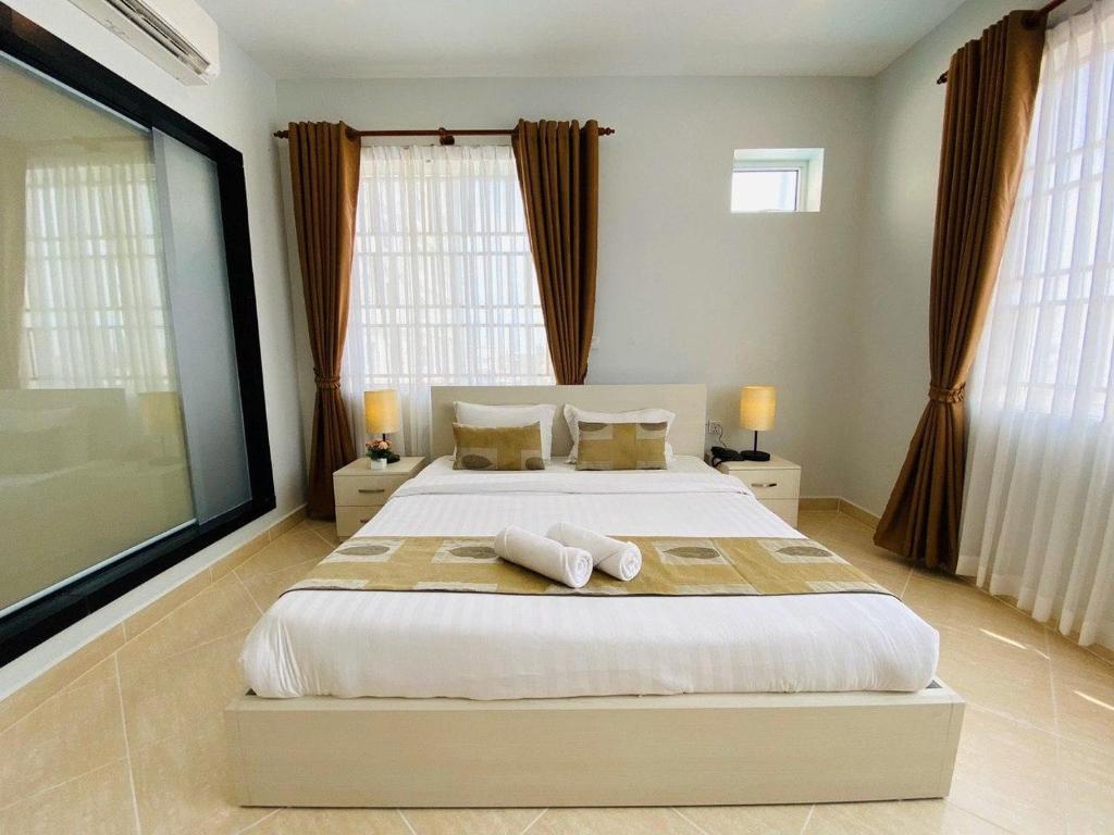 Postel nebo postele na pokoji v ubytování MekongView 1 CondoTel