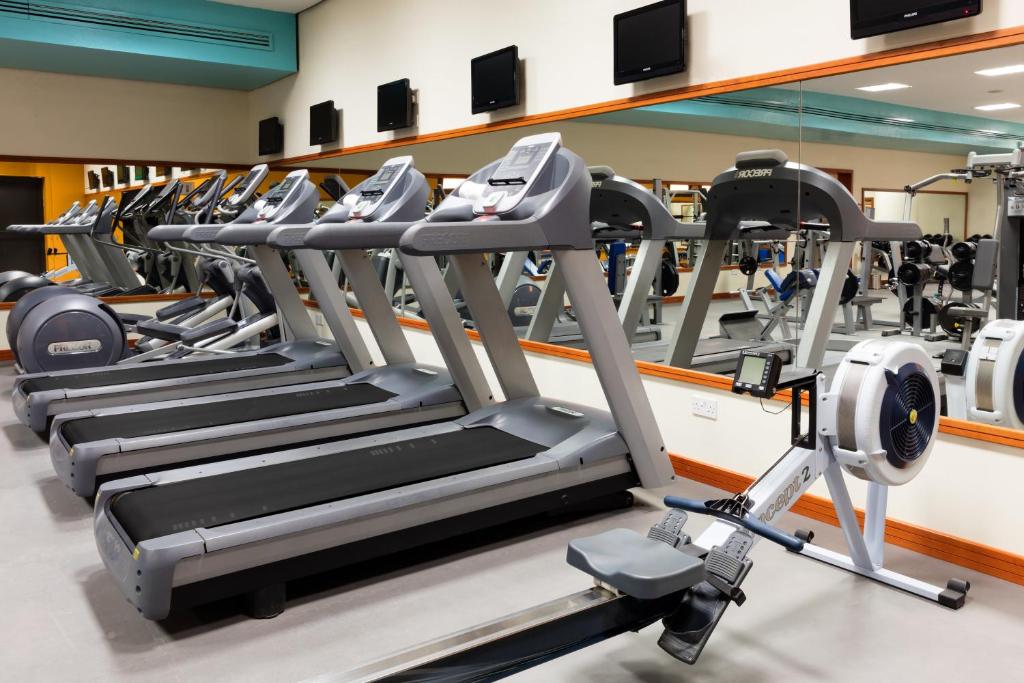 a row of tread machines in a gym at Crowne Plaza Bahrain by IHG in Manama