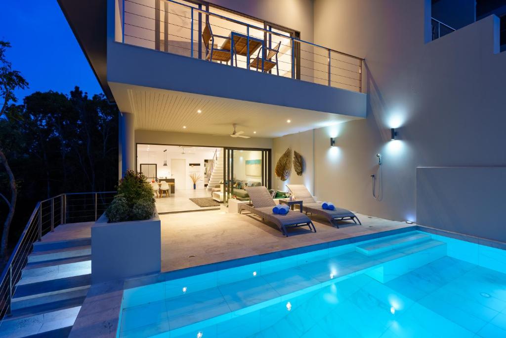 a villa with a swimming pool and a house at Villa Casa Bella - Private-Pool, Luxury Villa near Bangrak Beach in Koh Samui 