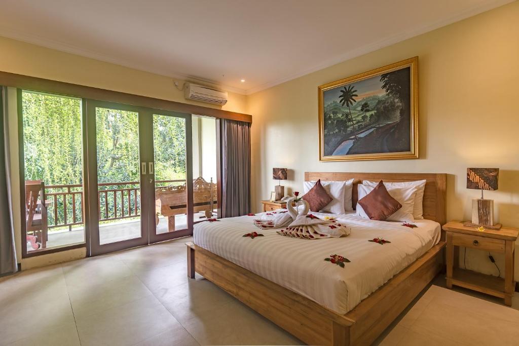 Postel nebo postele na pokoji v ubytování Alamdini Resort Ubud