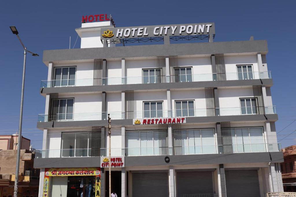 a hotel building with a sign on top of it at Hotel City Point in Phalodi