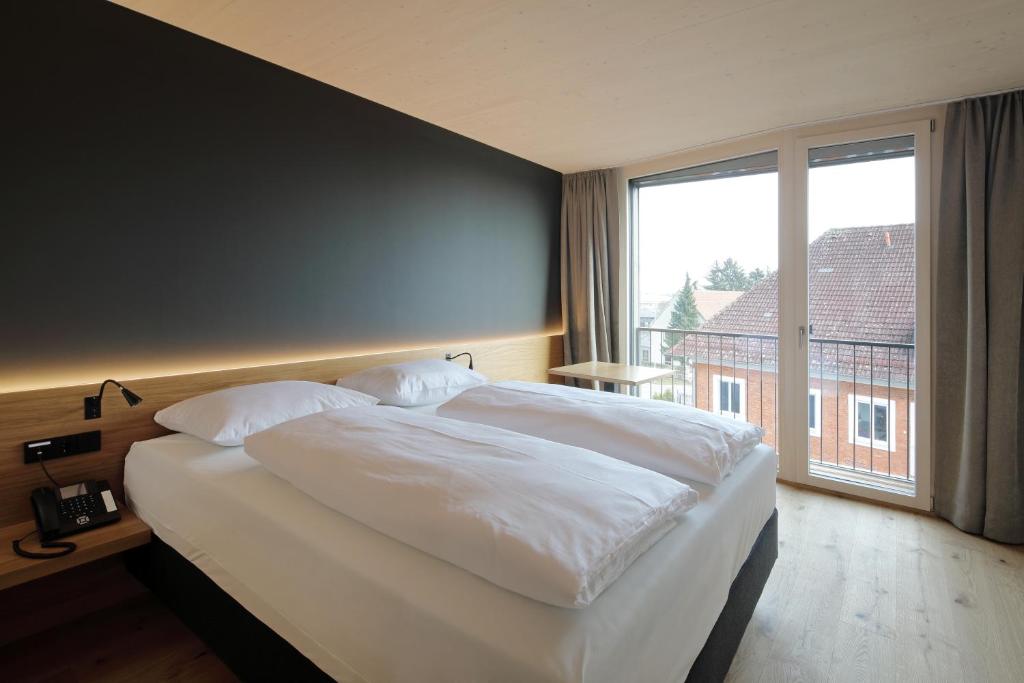 Postel nebo postele na pokoji v ubytování 2ND HOME HOTEL