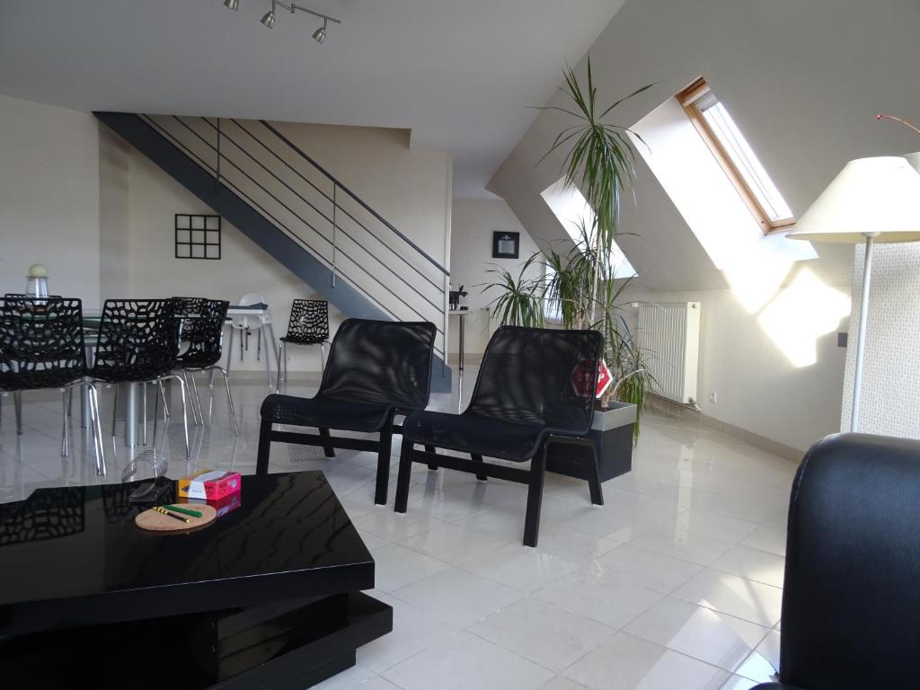 - un salon avec deux chaises et une table dans l'établissement Duplex residence d'orléans, à Amiens