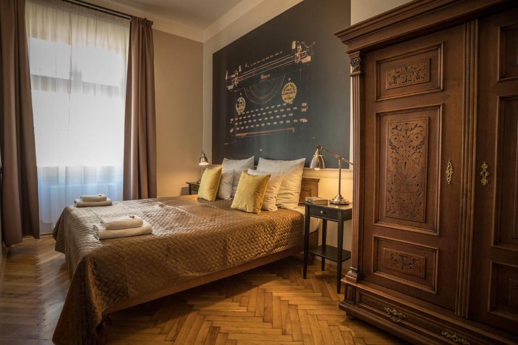 a bedroom with a bed and a large window at Scharffenberg Apartments Main Square in Krakow