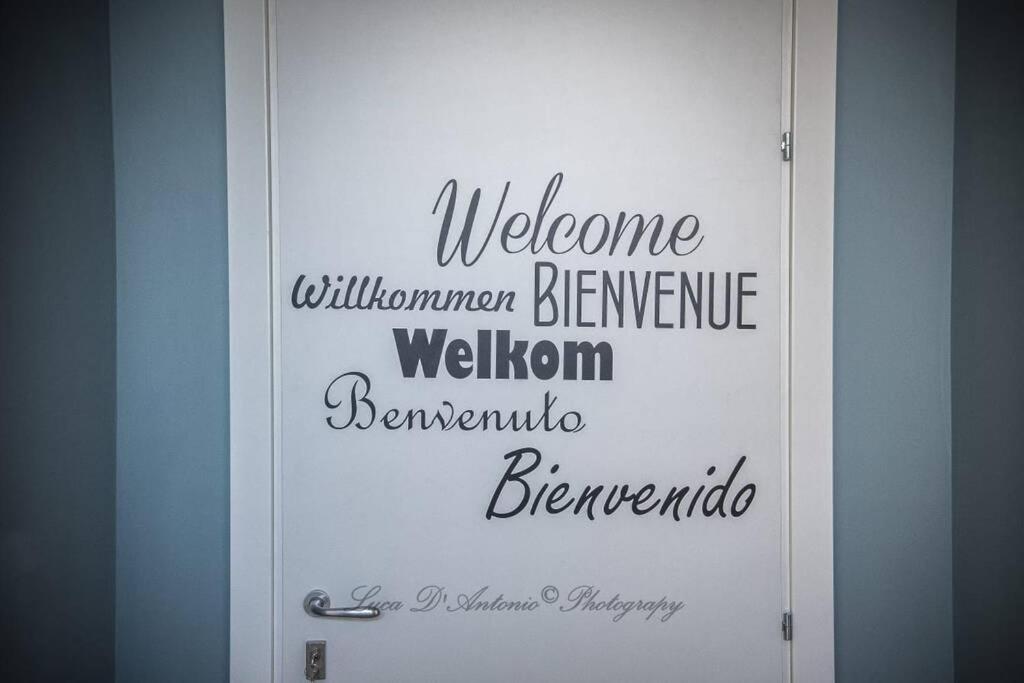 a white door with the words welcome welcomesmontonmonton welcome welcome benningtonsteensteen at Il Tamburino Lucio in San Gemini