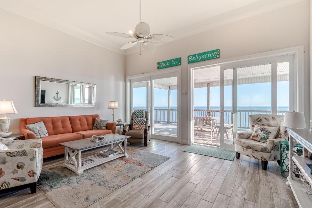 a living room with a couch and chairs at License to Chill in Dauphin Island