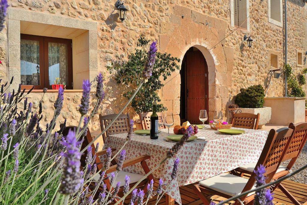 a table in a courtyard with a table cloth on it at Finca Rafal des Turó 061 by Mallorca Charme in Santa Margalida