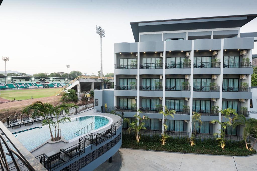 an apartment building with a swimming pool and a tennis court at Little Loft Hotel in Phuket Town