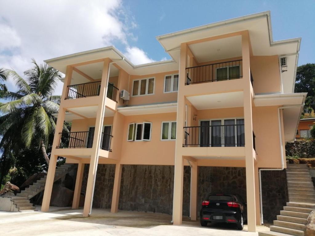 a house with a car parked in front of it at Jaidss Holiday Apartments 1 in Mahe