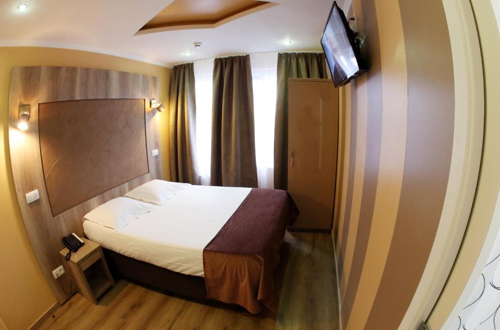 Postel nebo postele na pokoji v ubytování Hotel Phenix