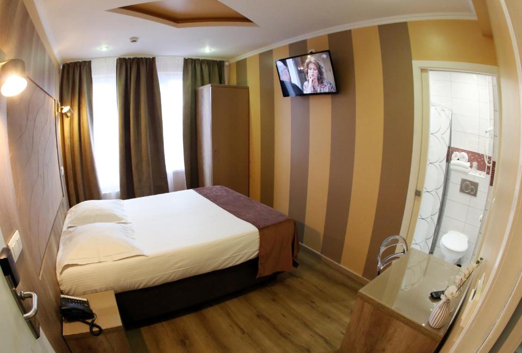 Postel nebo postele na pokoji v ubytování Hotel Phenix