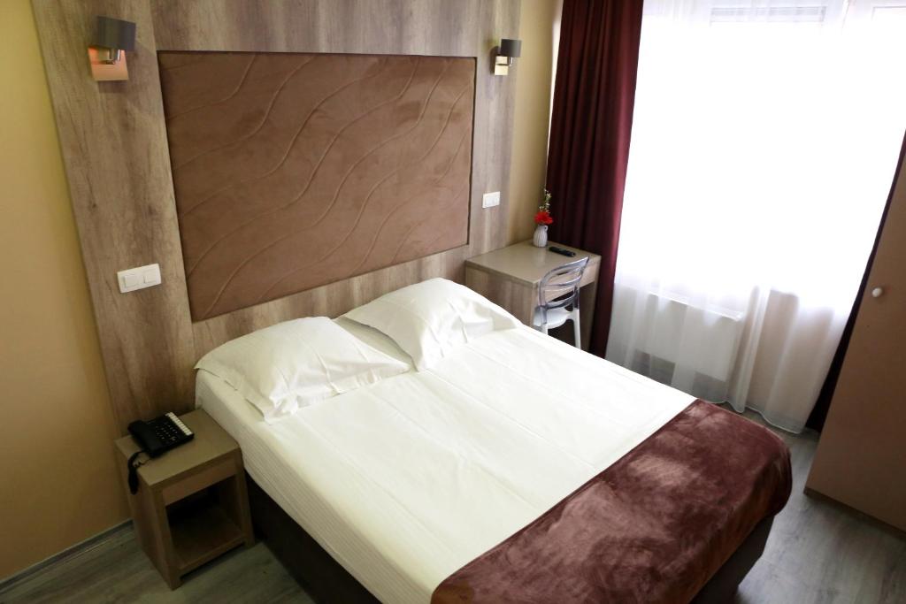 Postel nebo postele na pokoji v ubytování Hotel Phenix