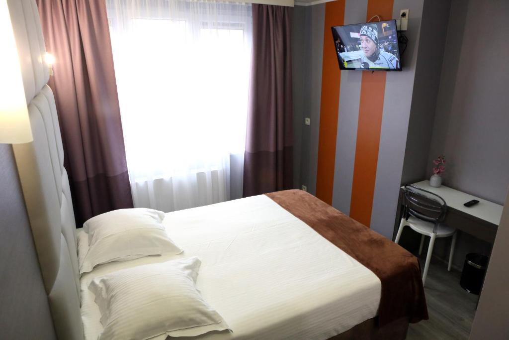 Postel nebo postele na pokoji v ubytování Hotel Phenix