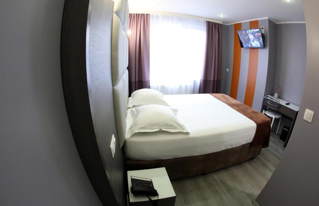 Postel nebo postele na pokoji v ubytování Hotel Phenix