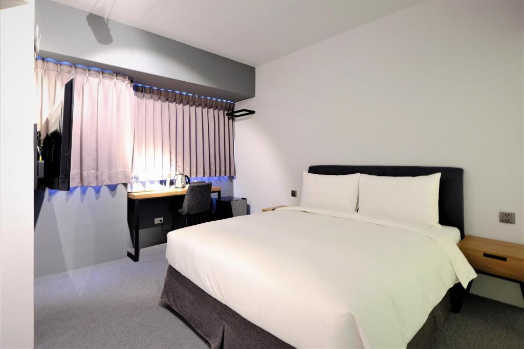 Postel nebo postele na pokoji v ubytování Doudian DDiNN Hotel