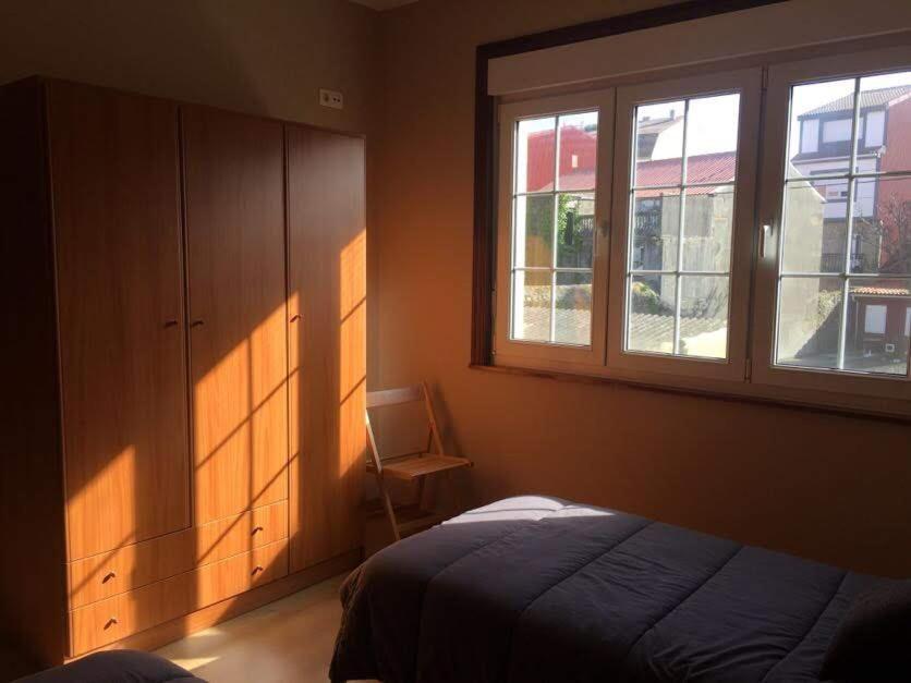 A bed or beds in a room at Pisos Turísticos Muxía -Teresa Barros