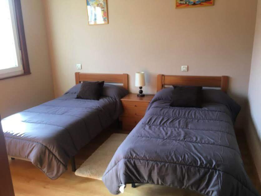 A bed or beds in a room at Pisos Turísticos Muxía -Teresa Barros