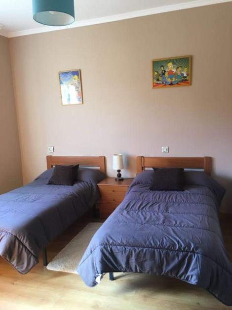 A bed or beds in a room at Pisos Turísticos Muxía -Teresa Barros