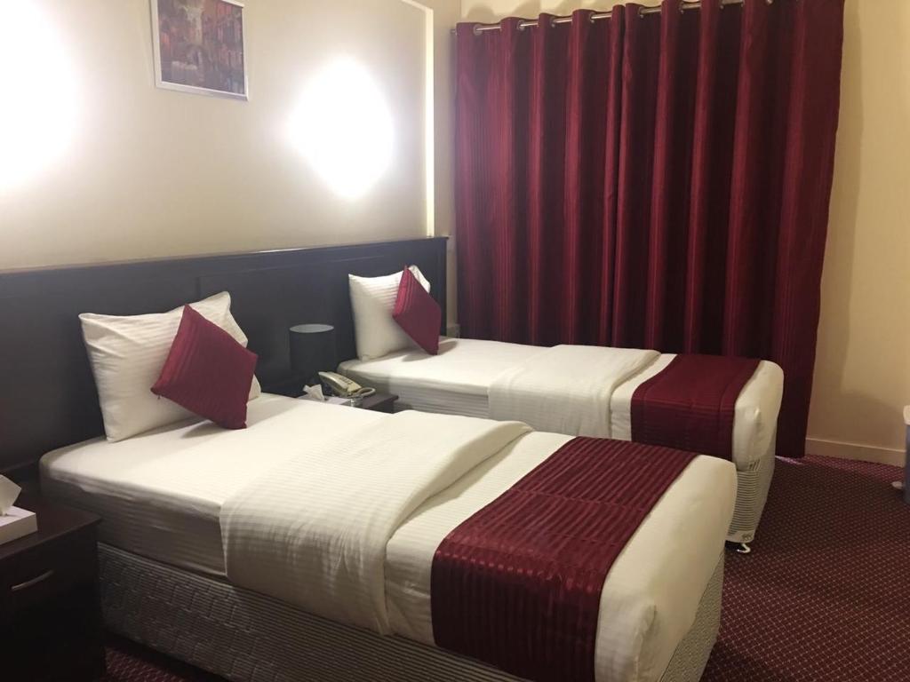 Postel nebo postele na pokoji v ubytování Simba Hotel