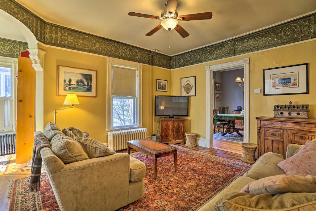 a living room with a couch and a ceiling fan at Historic House with Record Player, Walk to Downtown! in Roxbury