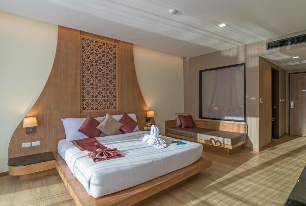 a bedroom with a large white bed in a room at Ananta Burin Resort - SHA Extra Plus in Ao Nang Beach