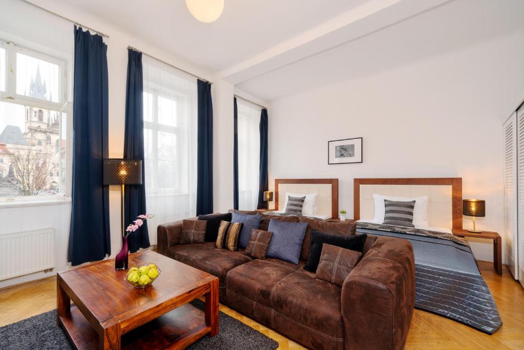 a living room with a couch and a bed at Old Town Square Premium Residence in Prague