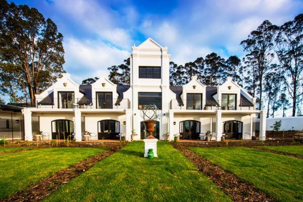 a large white house with a lawn in front of it at Fairview House in The Crags