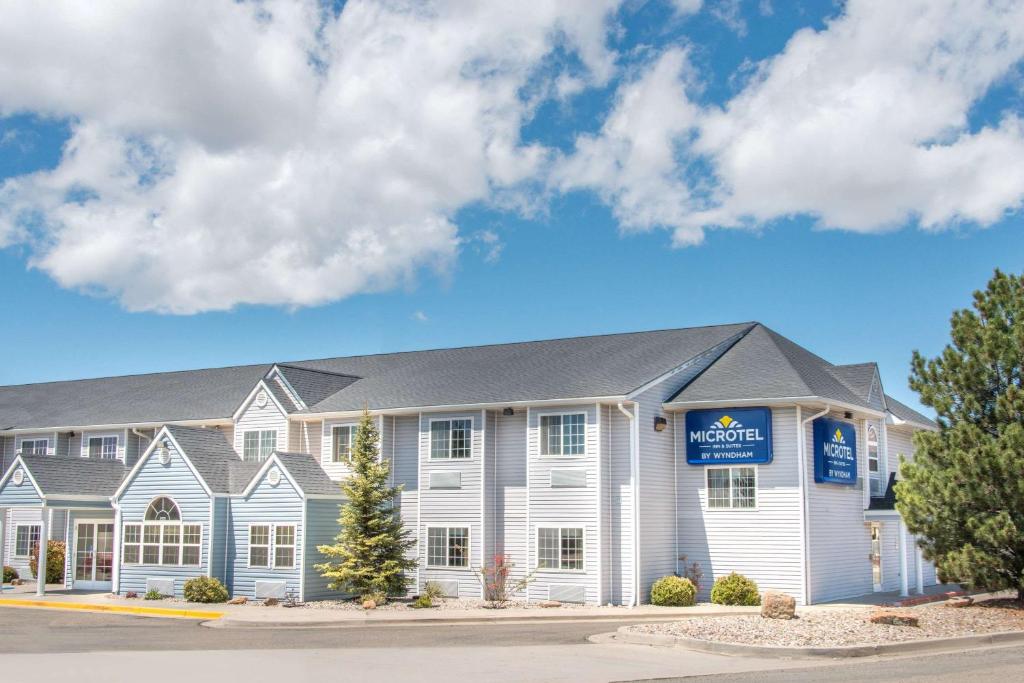 a hotel with a sign on the front of it at Microtel Inn & Suites in Raton