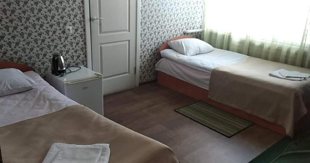 Postel nebo postele na pokoji v ubytování Hotel Gostynnyi Dvir
