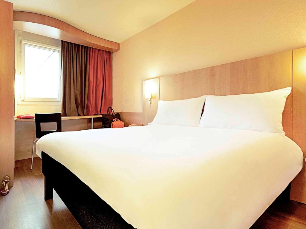 Uma cama ou camas num quarto em Hotel ibis Lisboa Jose Malhoa
