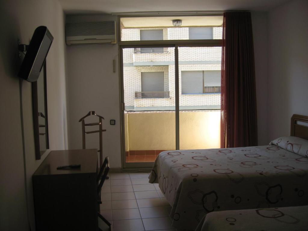 Postel nebo postele na pokoji v ubytování Hostal Fontdemora
