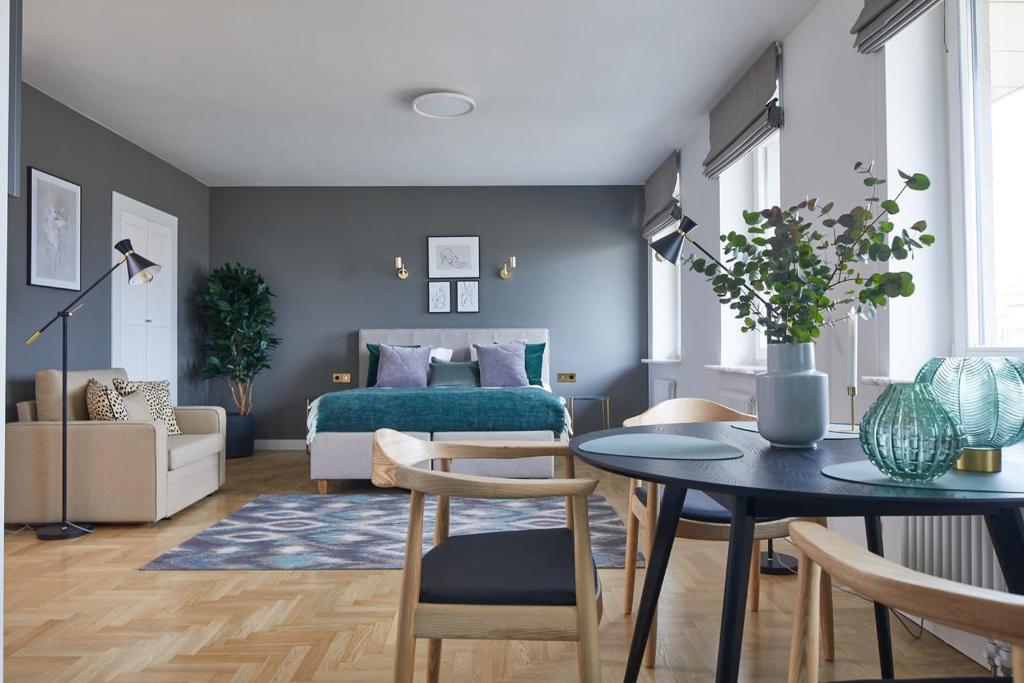 a living room with a bed and a table at Metro Politechnika Studio in Warsaw