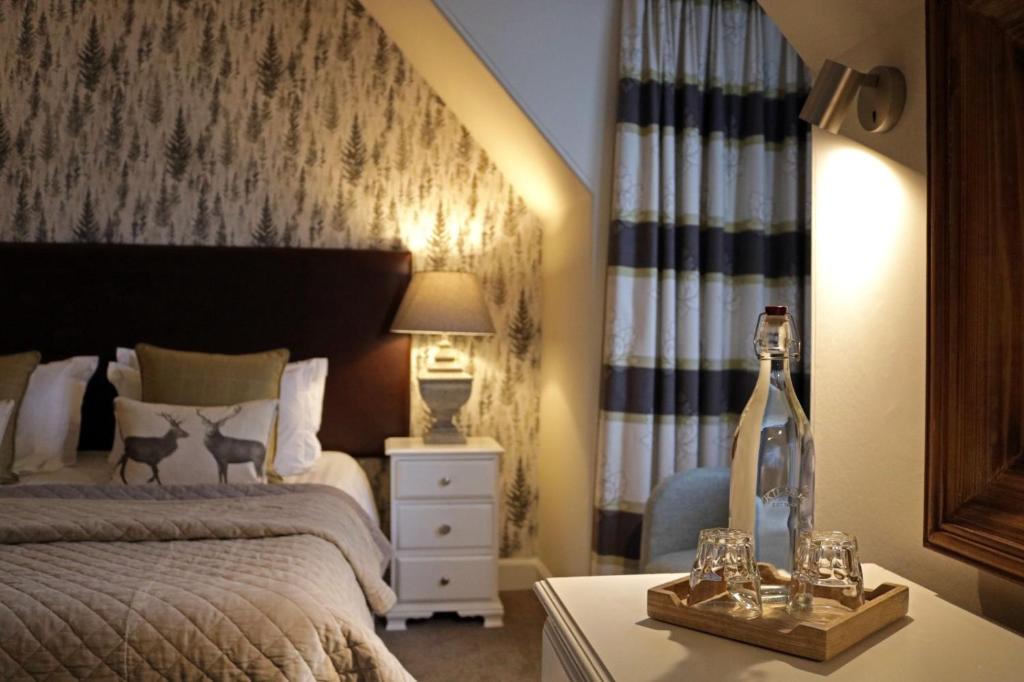 a bedroom with a bed and a table with a lamp at No12 Hotel in North Berwick