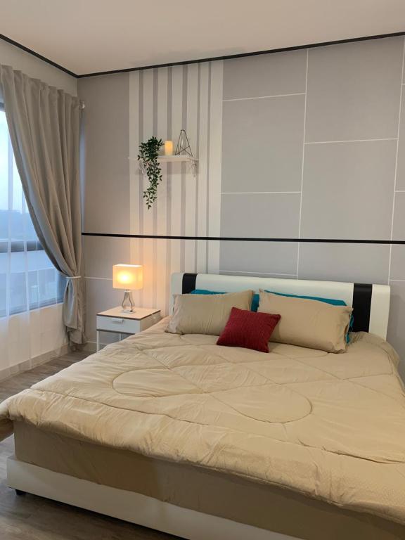 a bedroom with a large bed with two pillows at LuxStudio Tiara Imperio in Bangi