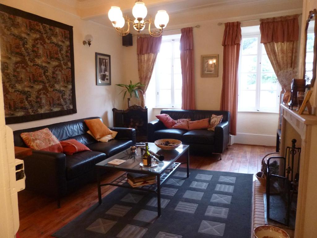 a living room with two couches and a table at Chateau View Chambres d'hôtes in Quillan