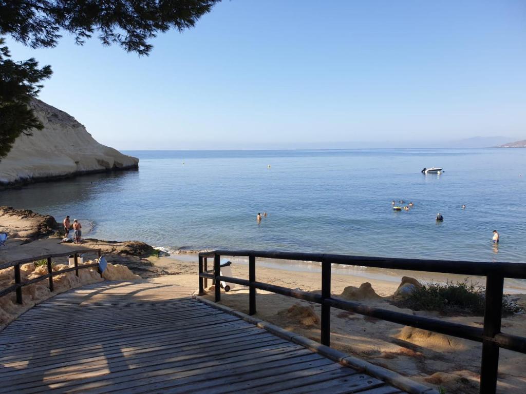 a group of people in the water at a beach at House Parra in San Juan de los Terreros