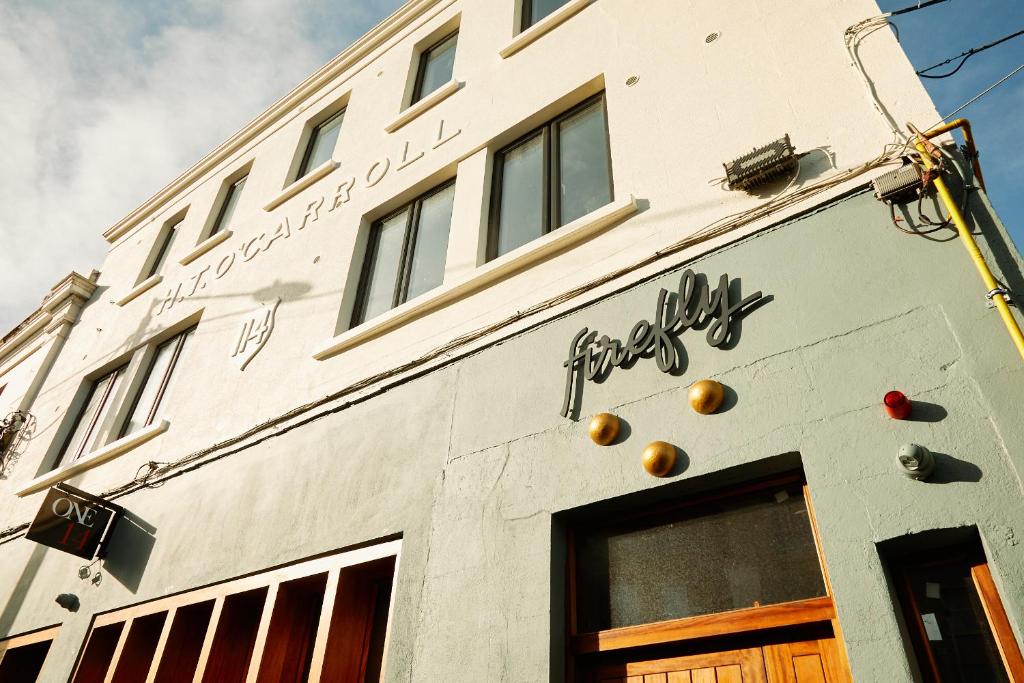 a white building with a sign on the side of it at Firefly in Bray