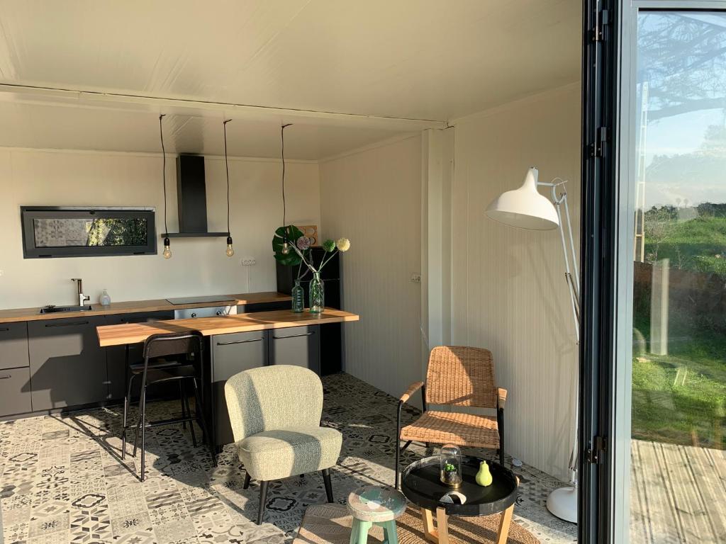a kitchen with a table and chairs in a room at Montinho Boutique Studio in Benagil