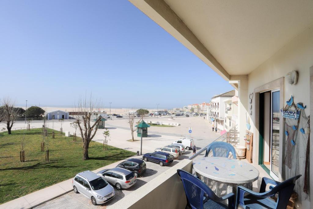 a balcony with cars parked in a parking lot at House Bay in Figueira da Foz