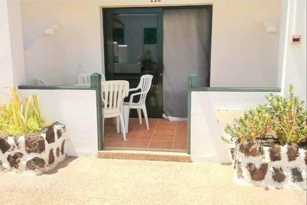 a patio with a table and chairs and plants at Giulia Puerto del Carmen in Puerto del Carmen