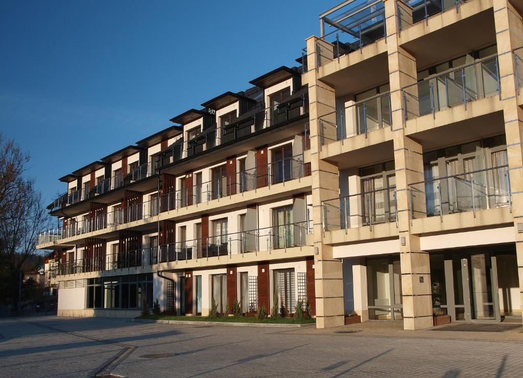 a large building with balconies on the side of it at Apartament Na Tęczowym Wzgórzu in Wisła