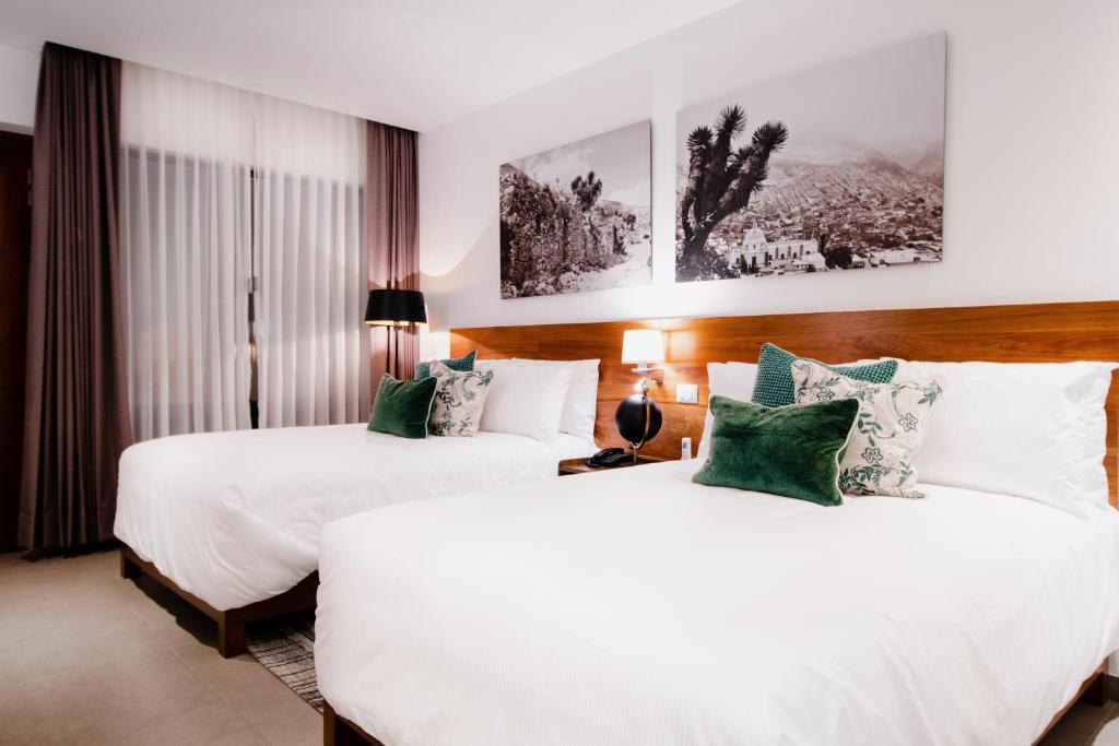 Postel nebo postele na pokoji v ubytování HOTEL MINA REAL MATEHUALA