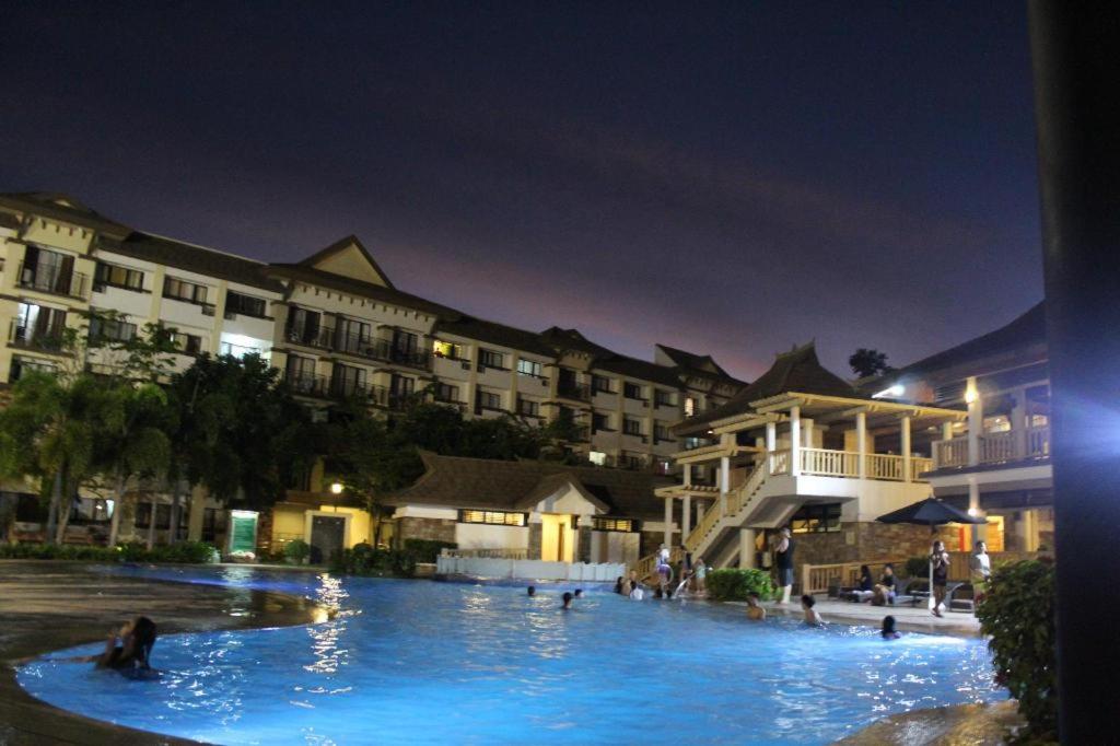 a large pool with people swimming in it at night at ONE OASIS B1 back of SM MALL, Free Pool Wifi in Davao City