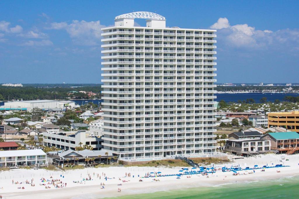 a large building on the beach with people on the beach at Seychelles Beach Resort III in Panama City Beach