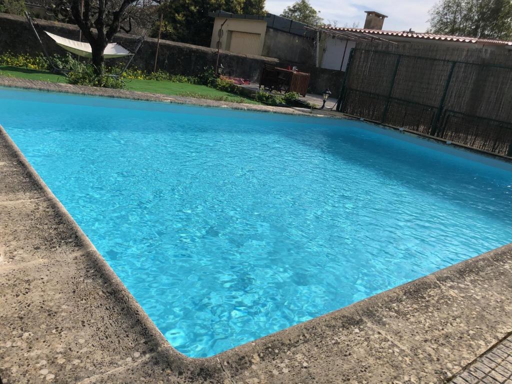 uma grande piscina azul num quintal em Sintra Nomad Lodge em Sintra